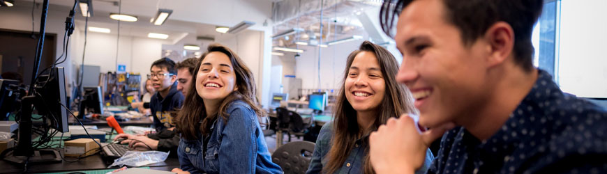 Students in a computer lab smiling